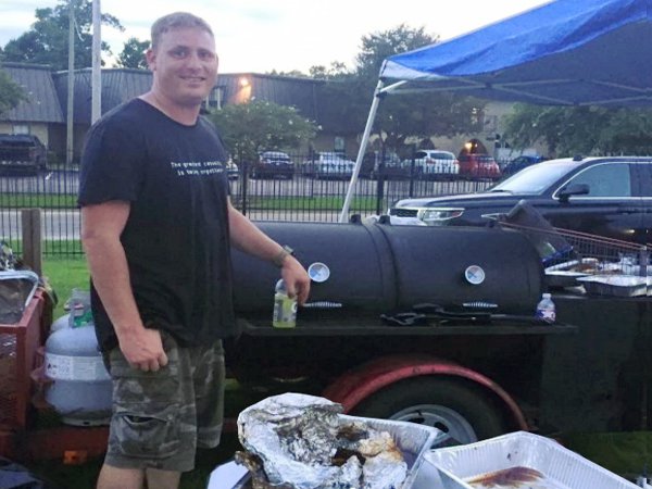 Christian Dornhorst serves barbecue to displaced flood victims. (Credit: Ashley Cusick for The Washington Post)