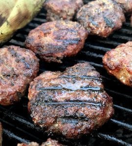 Crowd Cow Farm Select Ground Beef Sliders on the grill with corn