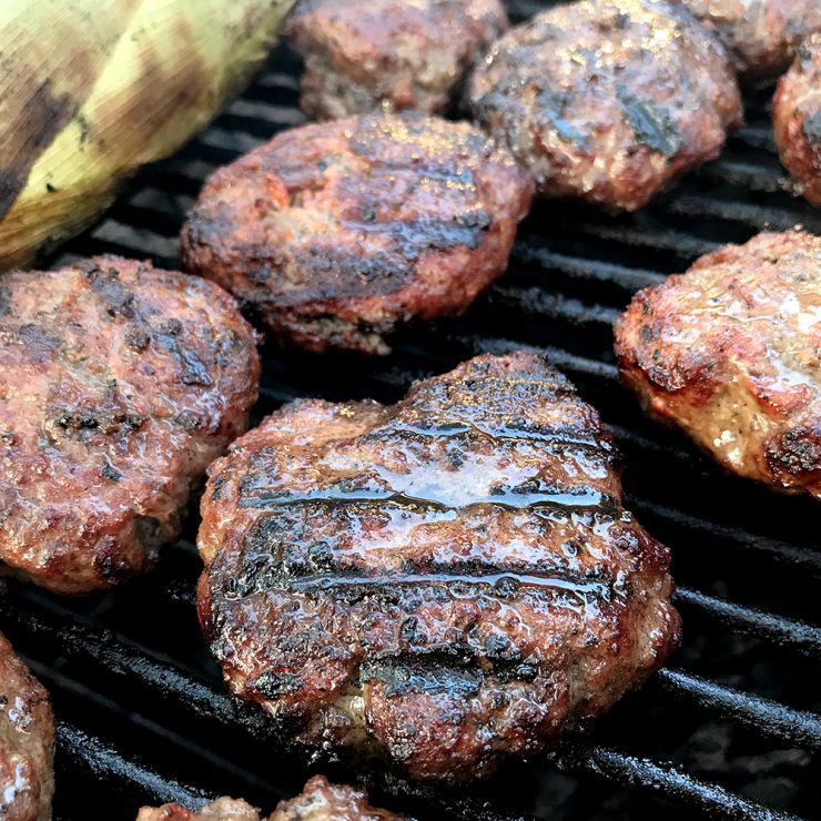 Crowd Cow Farm Select Ground Beef Sliders on the grill with corn