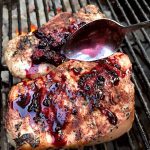 Pork chops on the grill with blackberry compote