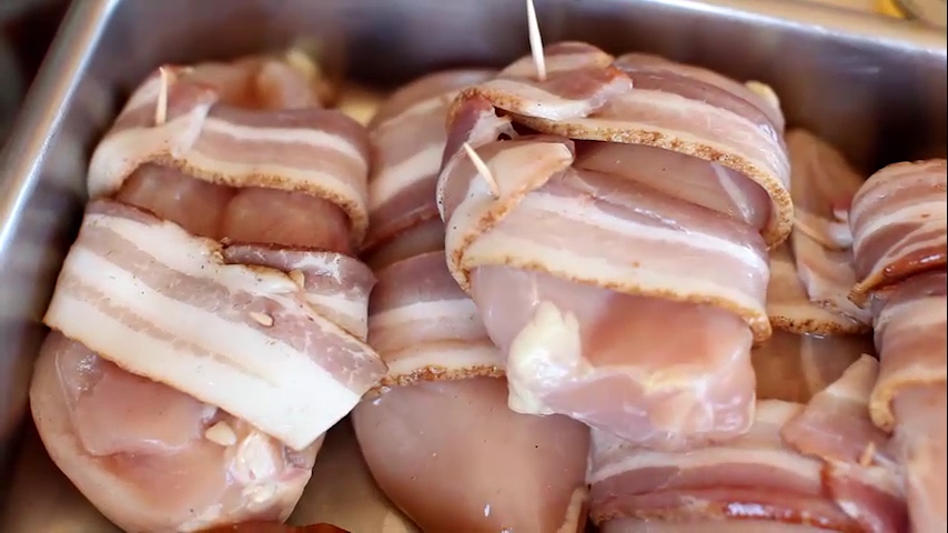 Wrap chicken breasts with bacon and secure with toothpick.