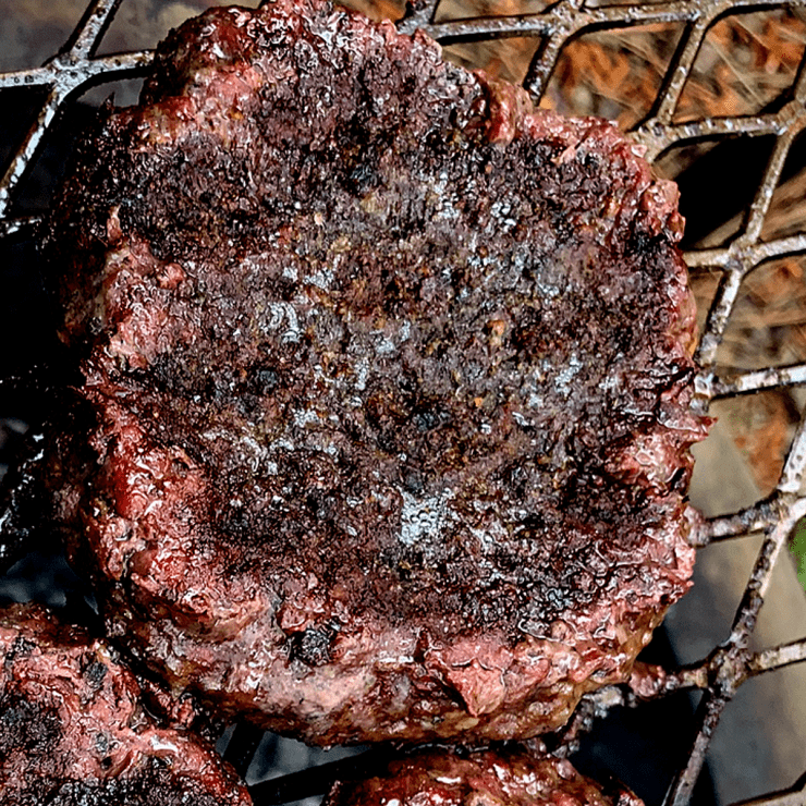 Caveman 2.0, 3/4 pound burger, seasoned with Gaston's Seasoning, on top of hardwood coals ramping up the flavor to an all-time high!