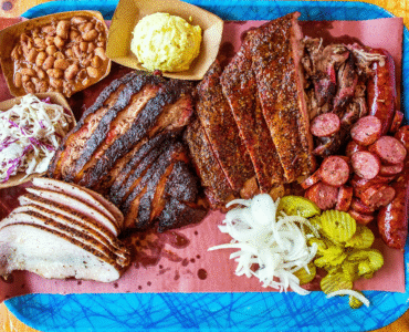 Plate of smoked meats and sides.